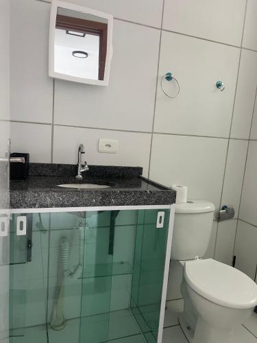 a bathroom with a toilet and a sink at AP Evangelista in Caruaru