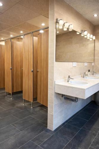 a bathroom with two sinks and a mirror at Hostel Layos, Toledo in Layos