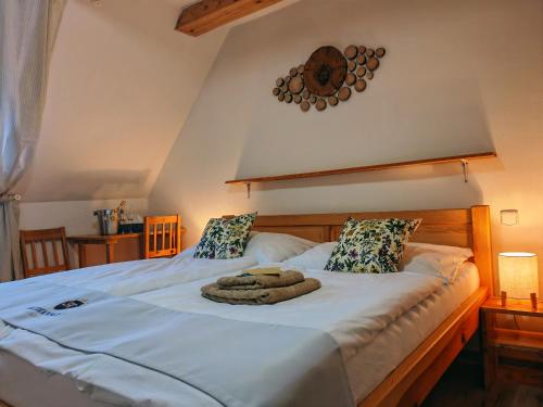 a bedroom with a bed with two towels on it at Althanský penzion in Znojmo