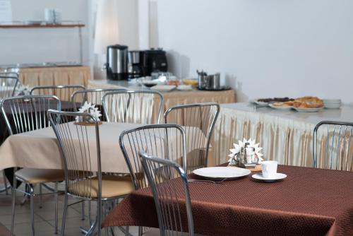 a dining room with a table and chairs at Luch Hotel in Moscow