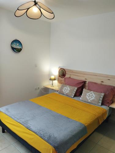 a bedroom with a large bed with colorful pillows at Dauphin bleu in Saint-André