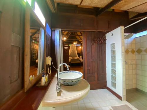 a bathroom with a bowl sink in a room at Sea Pines & Liberg in Nai Yang Beach