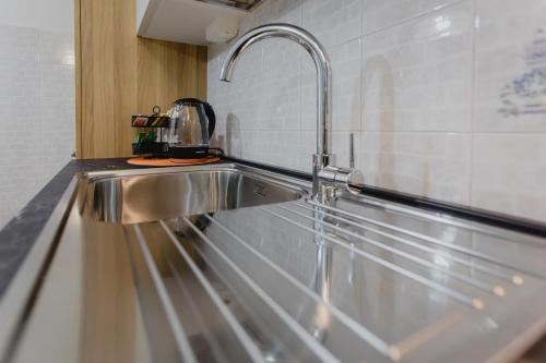 a stainless steel kitchen sink with a faucet at Casa Dama in Casaleone