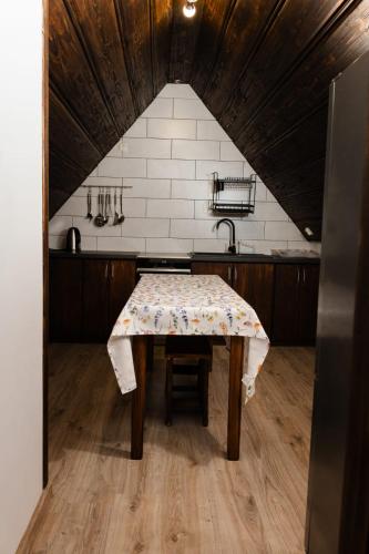 a kitchen with a table with a table cloth on it at Pokoje u Jozka-Widok na Tatry in Groń
