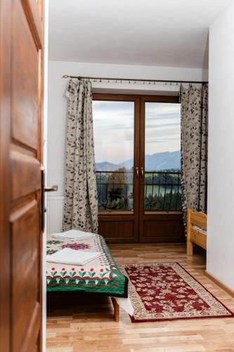 a door leading to a balcony with a view at Pokoje u Jozka-Widok na Tatry in Groń