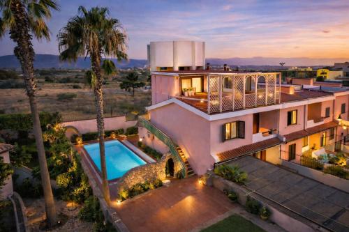 an aerial view of a house with a swimming pool at Vincent house in Quartu SantʼElena