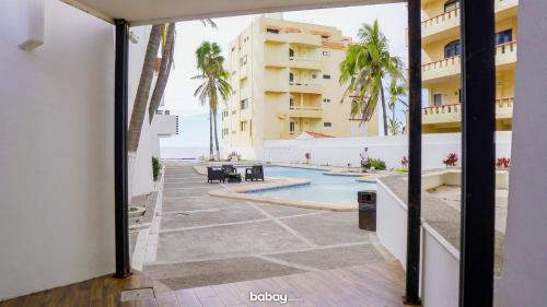 a view of the pool from the balcony of a hotel at Departamento con vista al mar, Marina del sol-Zona Cerritos in Mazatlán