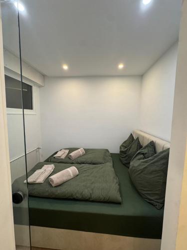 a bed in a room with two pillows on it at Black Forest Vista - Pool Sauna Tennis in Schonach