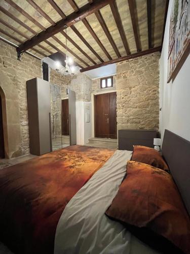 a large bed in a room with a stone wall at Casa vacanze La Fenice 2 in Pietranico