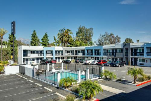 a parking lot in front of a building at Hotel Seville - Ontario Airport/Chino in Ontario