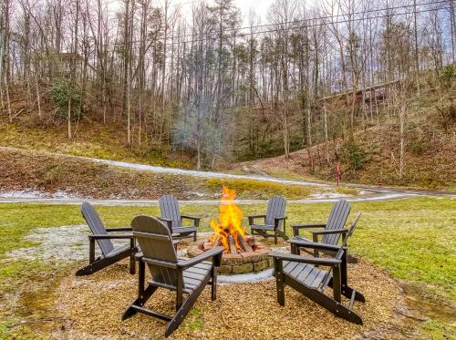 four chairs around a fire pit in a yard at Ole Red in Gatlinburg