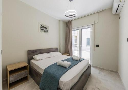 a bedroom with a bed with two towels on it at Relax Seafront Apartment by PS in Golem