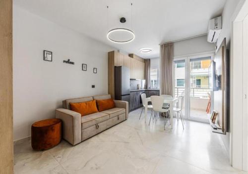 a living room with a couch and a table and chairs at Relax Seafront Apartment by PS in Golem