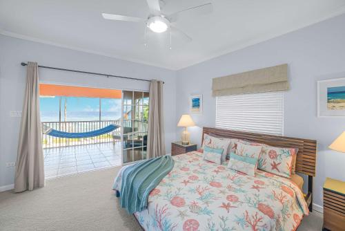 a bedroom with a bed with a view of the ocean at Northern Lights #6 Condo in Old Man Bay