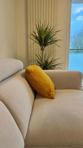 a yellow pillow sitting on the back of a couch at Casa Nostra in Białystok