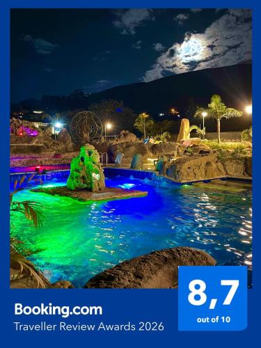 a pool at a theme park at night at Hotel Casa Cantabria Campestre in Villa de Leyva