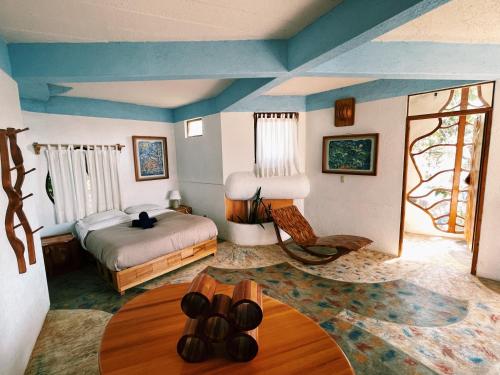 a bedroom with a bed and a table at El encinal in San Miguel