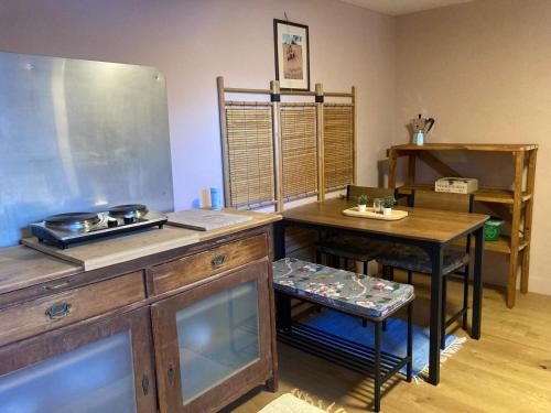 a kitchen with a counter and a table and a refrigerator at Baers Mountain Stay Außerbraz in Innerbraz