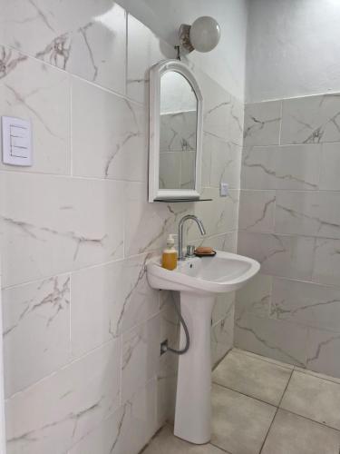 a white bathroom with a sink and a mirror at Alojamiento La Liboria, solo mujeres in Córdoba