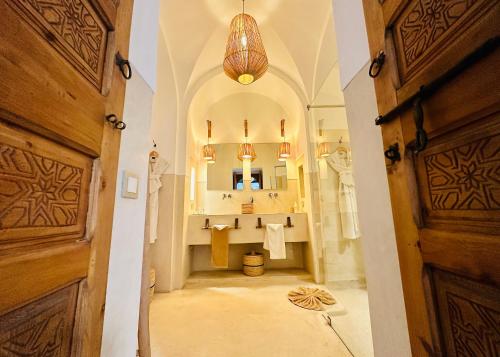 a large bathroom with a sink and a mirror at Riad Jardin Des Sens & Spa in Marrakesh