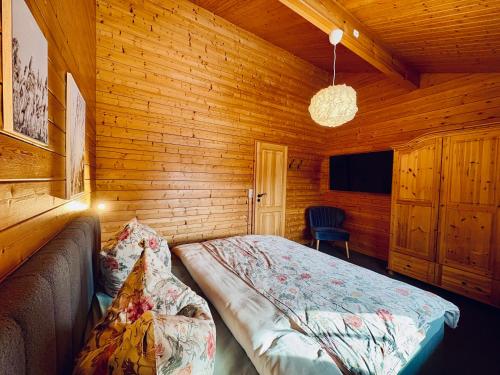 a bedroom with a bed in a wooden room at Küstenhaus Silbermöwe in Cuxhaven