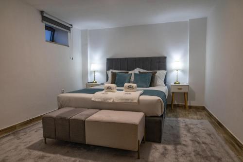 a bedroom with a large bed with two towels on it at Casa da Eira Campia in Vouzela