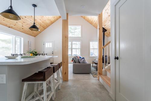 a kitchen with wooden ceilings and a counter with a bar at Lakefront with Private Dock & Canoe Kenoza Den in Jeffersonville