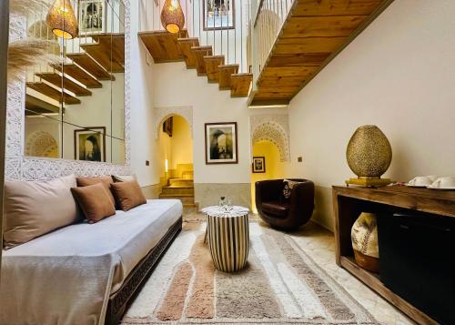a living room with a couch and a table at Riad Jardin Des Sens & Spa in Marrakesh