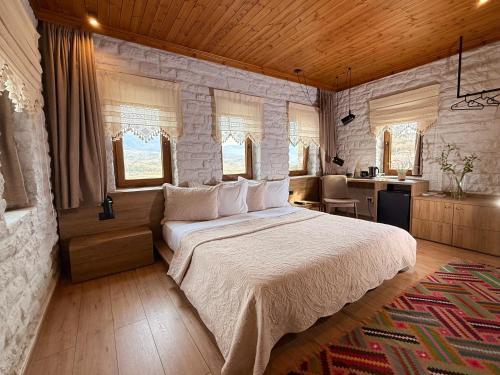 a bedroom with a large bed in a room at The Stone Sky Hotel in Gjirokastër