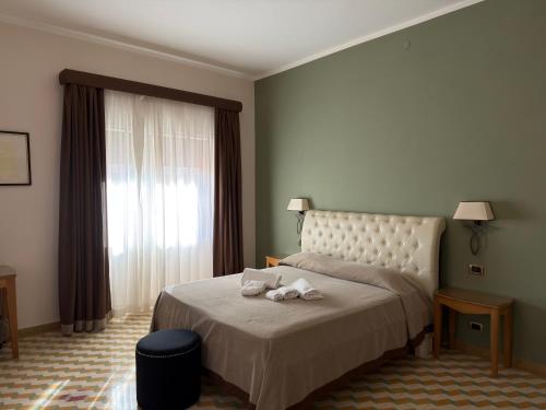 a hotel room with a bed with towels on it at Albergo Russo in Trapani