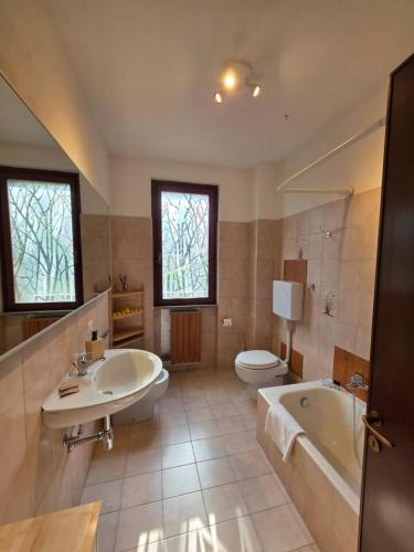 a bathroom with a tub and a sink and a toilet at Easy Albese Comfort in Albese Con Cassano