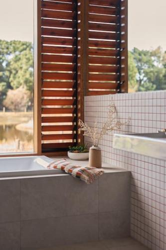 a bathroom with a bath tub and a window at Ellas Rest in Torquay