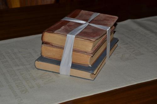 a stack of books with a bow on top at Kenhardt Hotel in Kenhardt