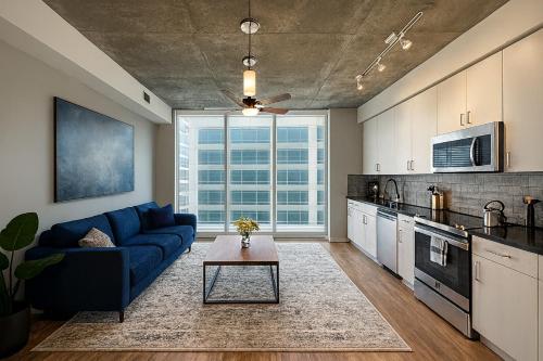 a living room with a blue couch in a kitchen at The Downtown Gem Modern Luxe Escape 4 in Birmingham