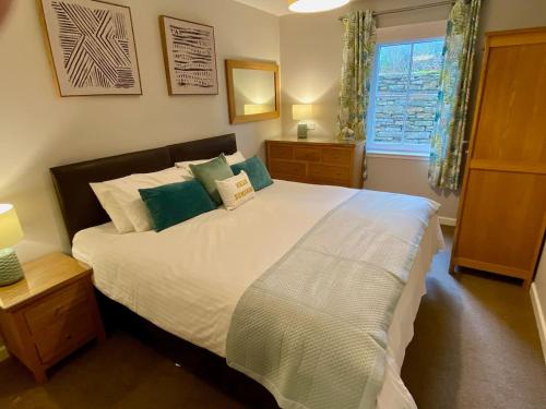 a bedroom with a large bed and a window at Kirkwall town centre apartment 1 in Kirkwall