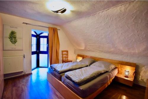 a bedroom with a large bed in a room at Fewo Eifel Dahlem Nationalpark Sonnenterrasse & Kamin in Dahlem