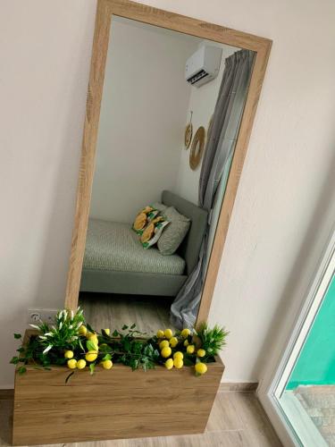 a mirror in a room with a couch and some fruit at Lemon Luxury Studio in Xanthi