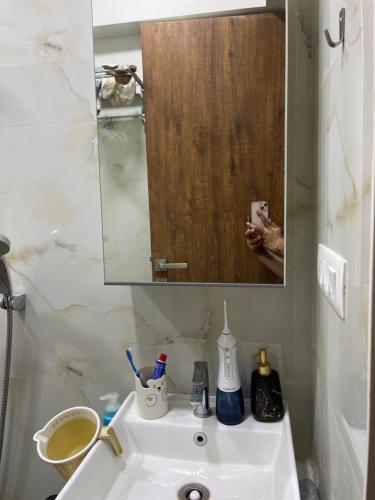 a bathroom with a white sink and a mirror at Sumeru in Mumbai