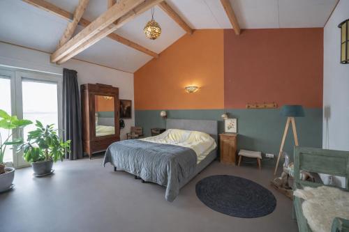 a bedroom with a bed and a table in a room at Beautiful Countryside house, close to Amsterdam in Broek in Waterland