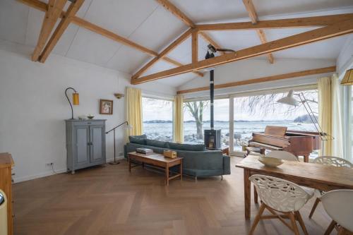 a living room with a couch and a piano at Beautiful Countryside house, close to Amsterdam in Broek in Waterland