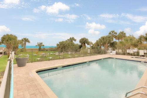 a swimming pool in a yard with a fence at Oceanview King Suite @ Meridian Plaza by Wavecrest Beach Vacations in Myrtle Beach