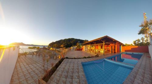 a resort with a swimming pool and a building at Hotel Guarakessaba in Guaraqueçaba
