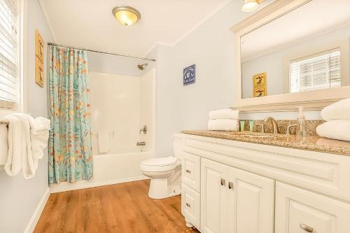 a white bathroom with a toilet and a shower at Crescent Beach 3 Bedroom with Pool, Across the Street from Ocean in Myrtle Beach