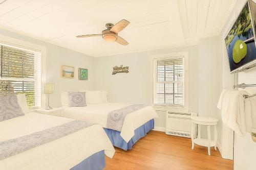 a bedroom with two beds and a ceiling fan at Crescent Beach 3 Bedroom with Pool, Across the Street from Ocean in Myrtle Beach