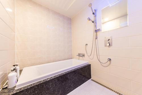 a bathroom with a tub and a shower at Boutique Hotel SB Yeouido in Seoul