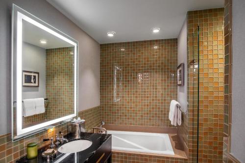 a bathroom with a tub and a sink and a shower at Hotel Adagio, Autograph Collection in San Francisco