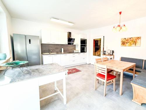 a kitchen with a table and a dining room at Villa Acereto by Interhome in Nassereith