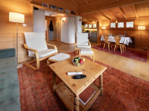 a living room with a table and white chairs at Apartment Ker Eol by Interhome in Villars-sur-Ollon
