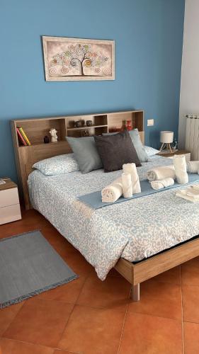 a bedroom with a bed with towels on it at Casa Vacanze Palidoro Il Plumbaco in Palidoro