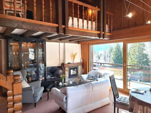 a living room with white furniture and a large window at Apartment Le Sporting by Interhome in Champex